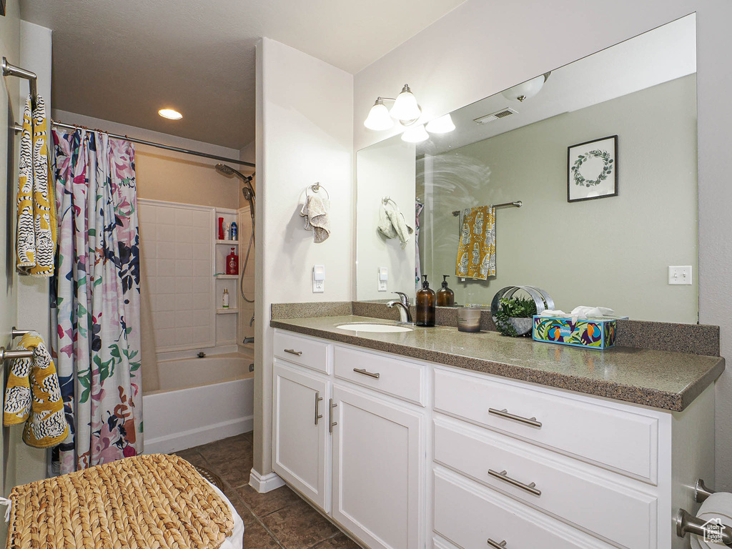 Bathroom with tile patterned floors, vanity, shower / bathtub combination with curtain, and recessed lighting