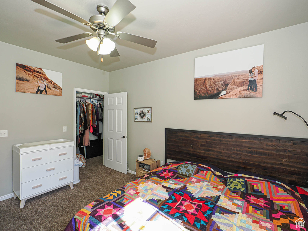 Bedroom featuring dark carpet, a closet, a ceiling fan, and baseboards