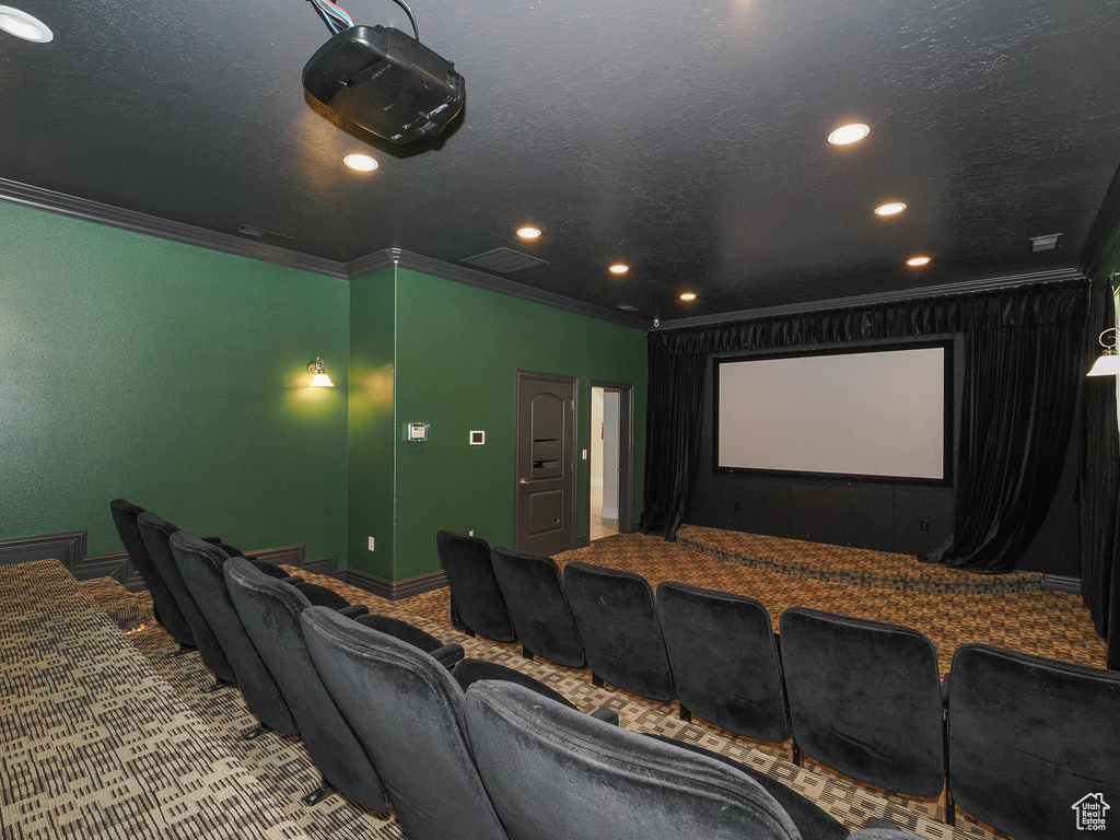 Cinema room with crown molding, baseboards, recessed lighting, and carpet