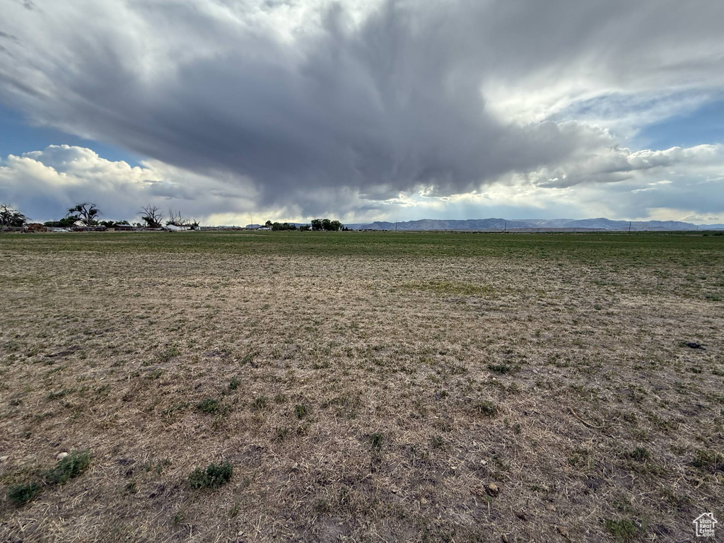View of yard with a rural view and a mountain view