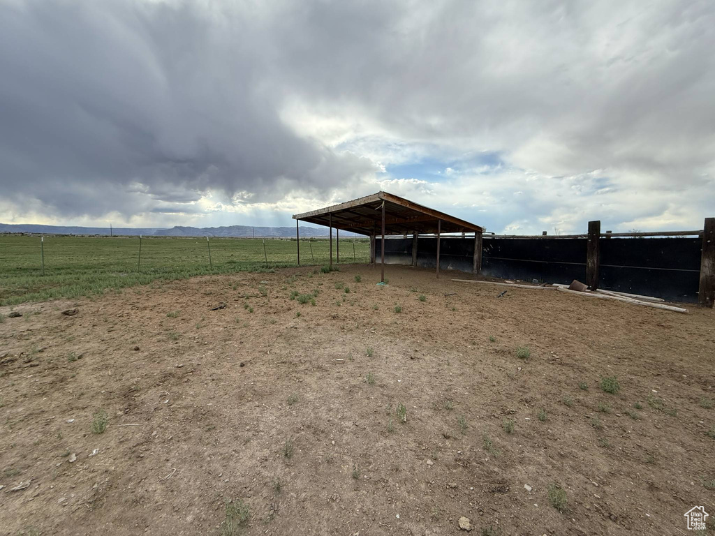 View of yard with an outbuilding, an exterior structure, and a carport