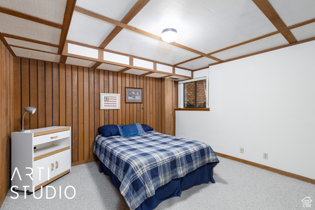 Bedroom featuring baseboards, carpet flooring, and wooden walls