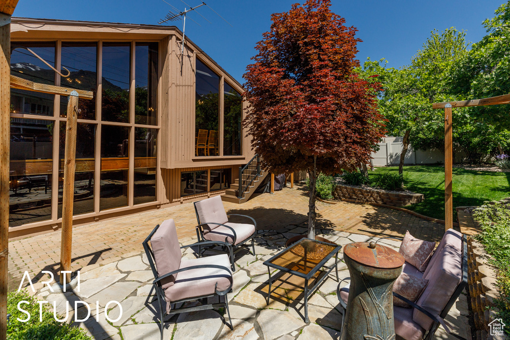 View of patio / terrace with stairs and a sunroom
