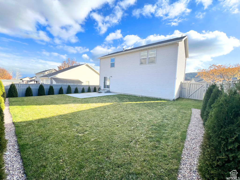 Rear view of property with a patio area and a gate
