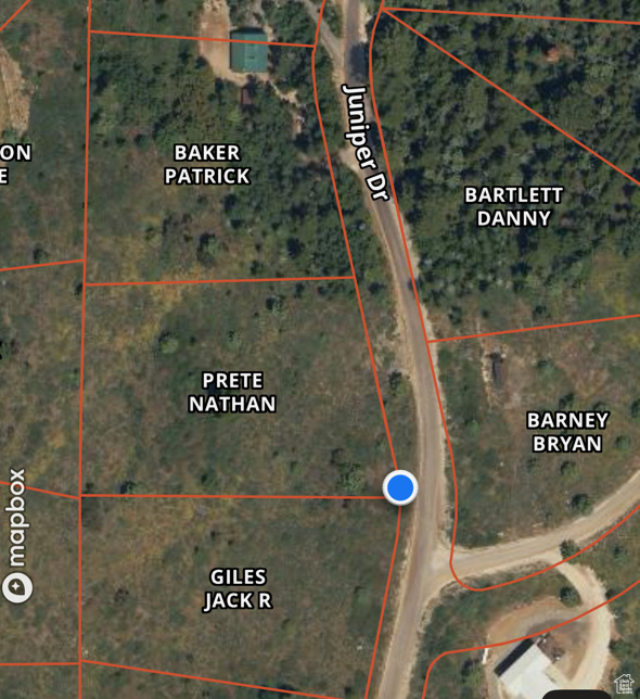 Aerial map of property and surrounding area featuring property boundaries highlighted