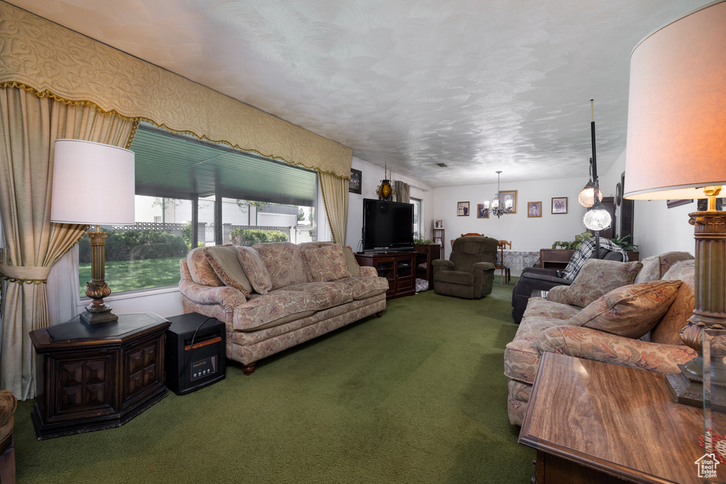 Carpeted living area with a chandelier