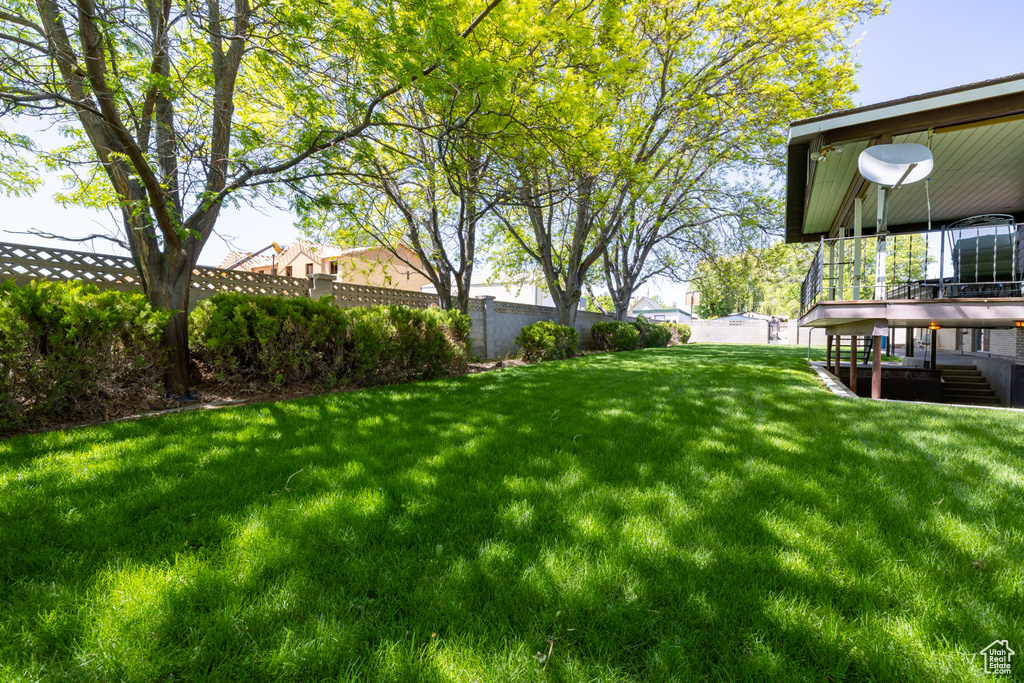 View of yard featuring a deck and stairs