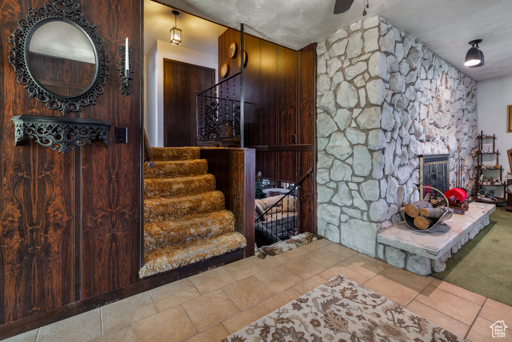 Stairway featuring a fireplace and tile patterned flooring