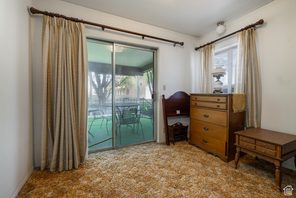 Carpeted bedroom featuring access to outside