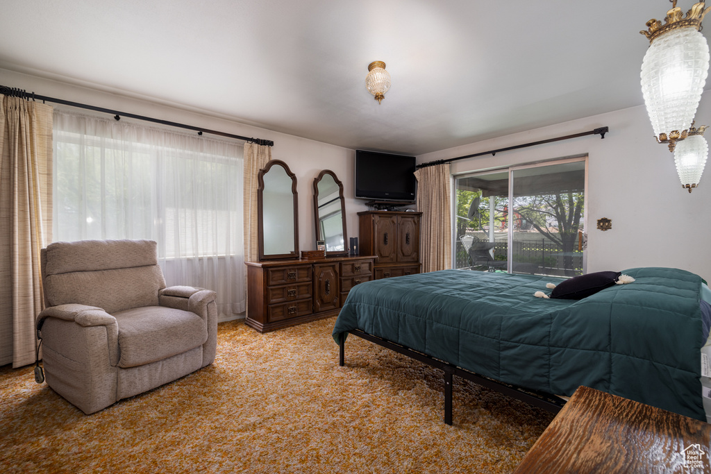 Bedroom featuring access to exterior and light colored carpet