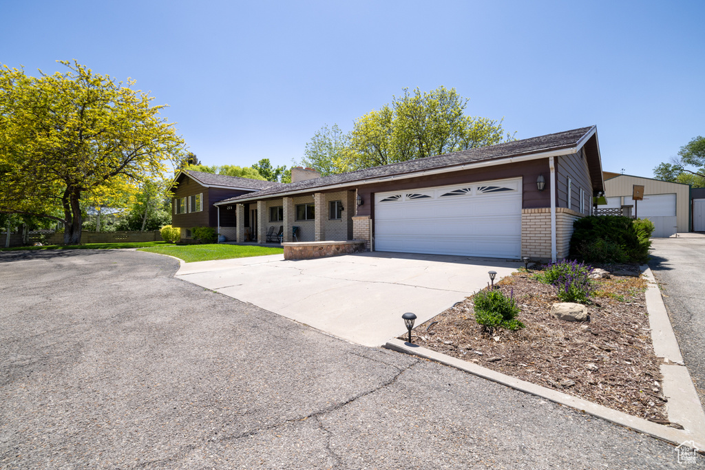 Ranch-style home with brick siding, a garage, and concrete driveway