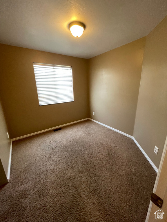 Spare room with carpet flooring and baseboards