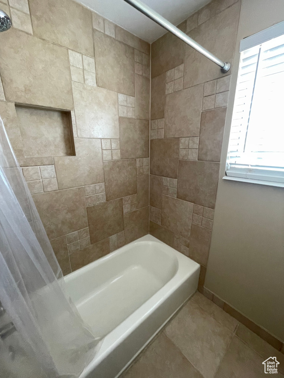 Full bathroom with shower / bath combination with curtain, baseboards, and tile patterned floors