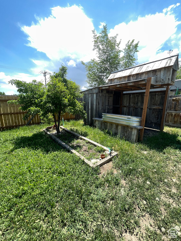 View of yard with an outdoor structure and a pole building