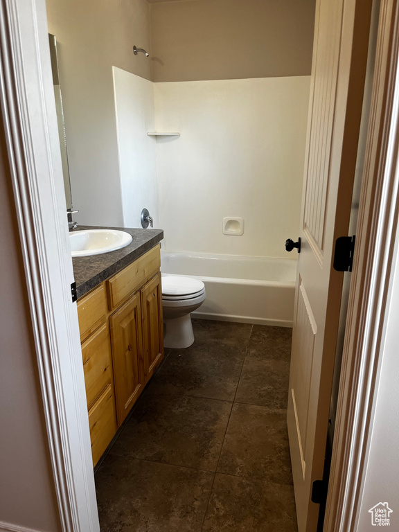 Bathroom featuring vanity, toilet, and tub / shower combination