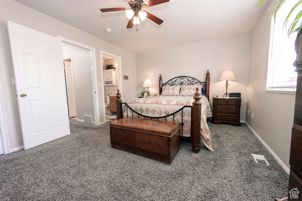 Bedroom with carpet, ensuite bath, baseboards, and ceiling fan