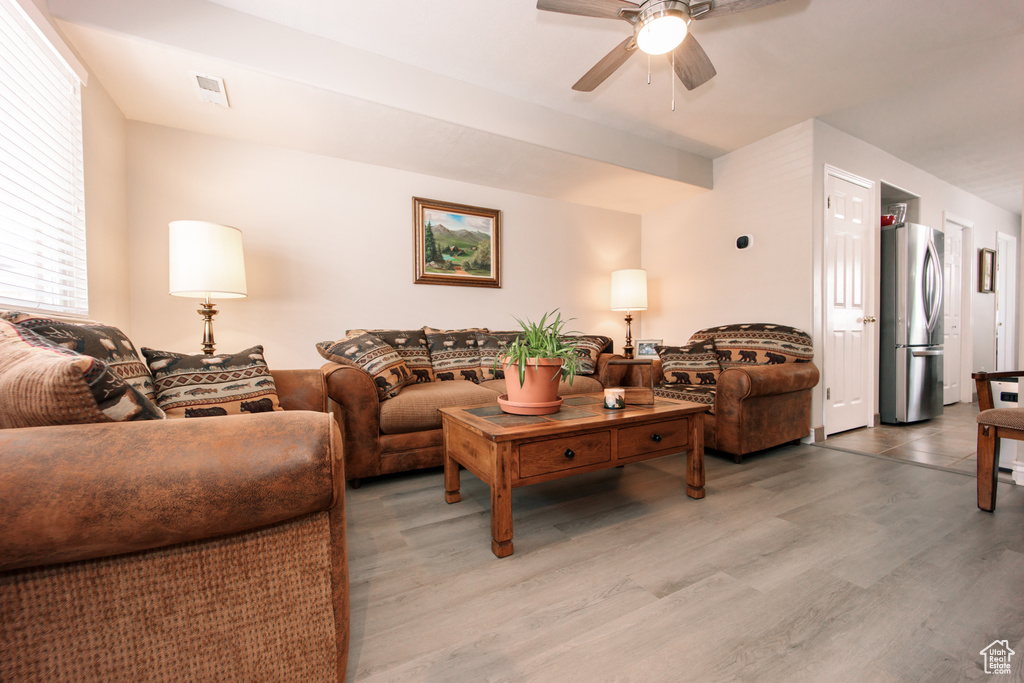 Living room with a ceiling fan and wood finished floors