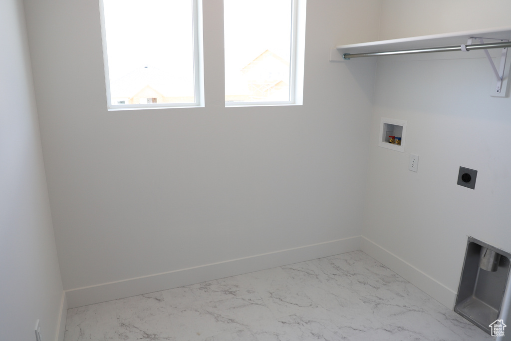 Washroom featuring washer hookup, baseboards, electric dryer hookup, and marble finish floors