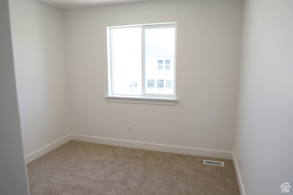 Unfurnished room with carpet floors and baseboards