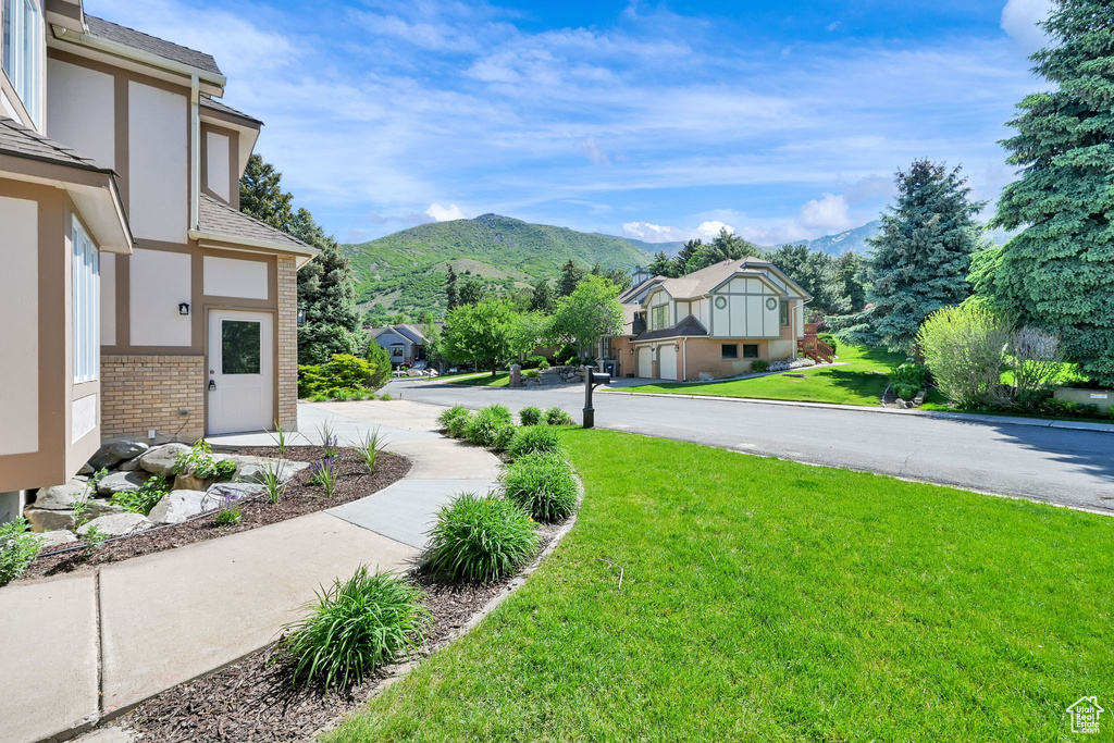 View of grassy yard featuring a mountain view