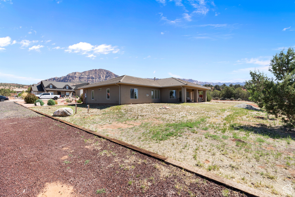 View of side of property with a mountain view