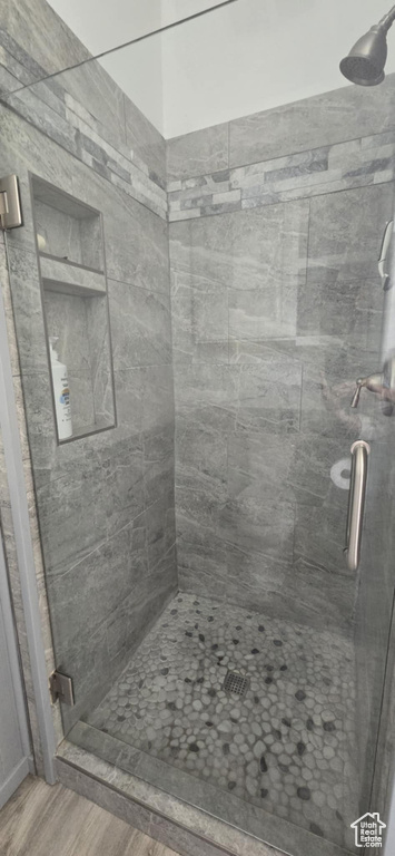 Bathroom featuring a stall shower and wood finished floors