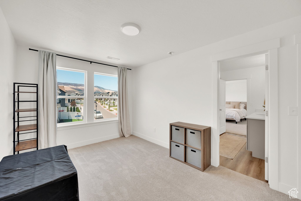 Bedroom featuring carpet floors and baseboards