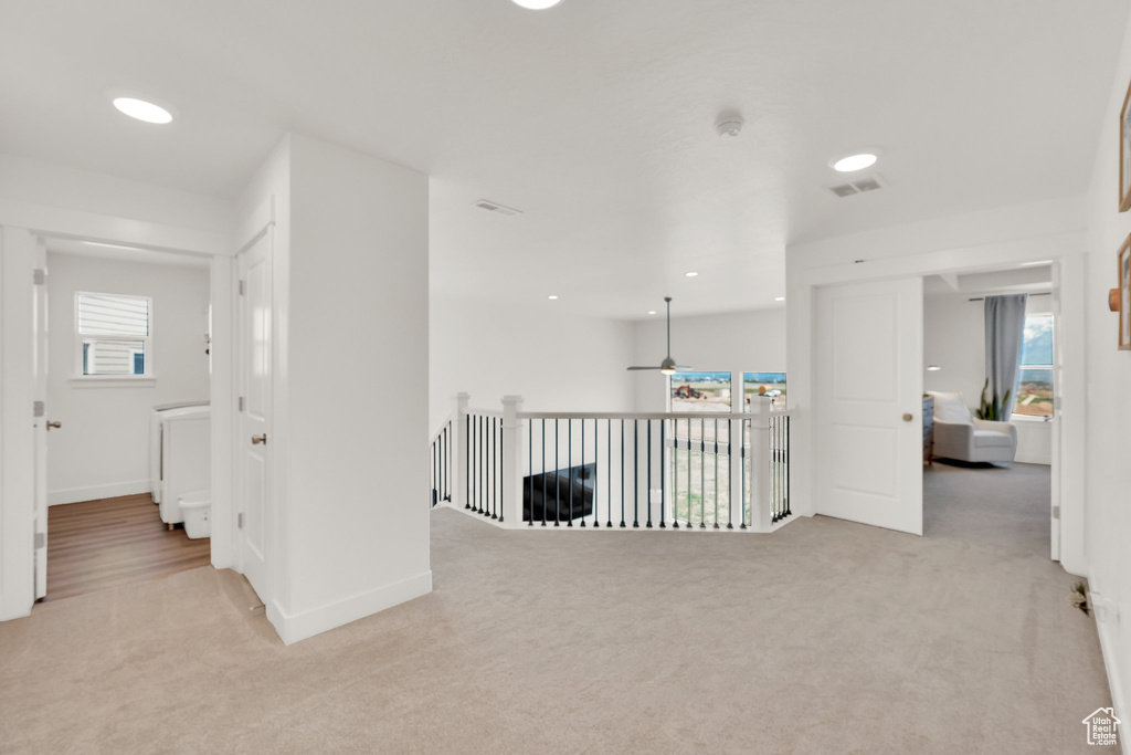 Hallway with carpet floors, baseboards, and recessed lighting