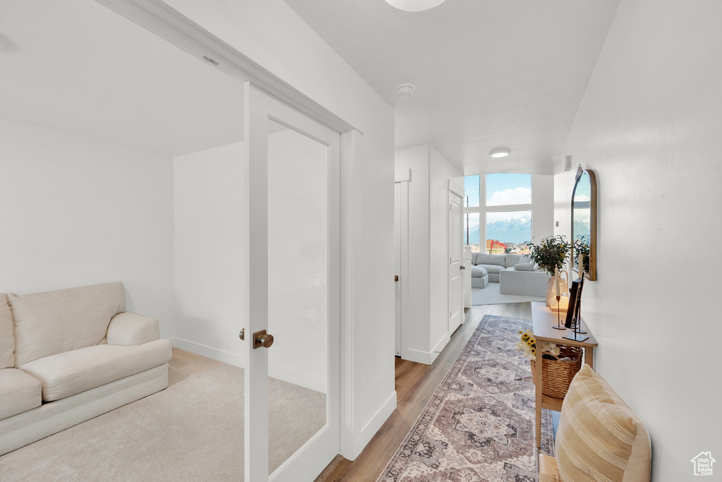 Hall featuring baseboards and light wood-style floors