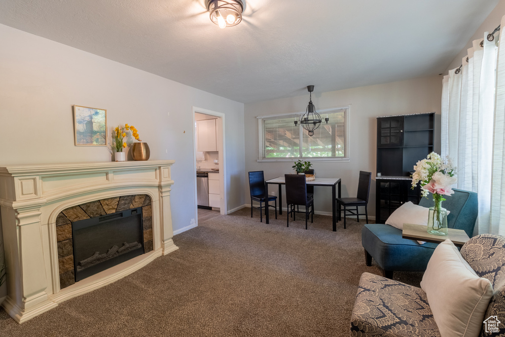 Living room with carpet, baseboards, and a fireplace