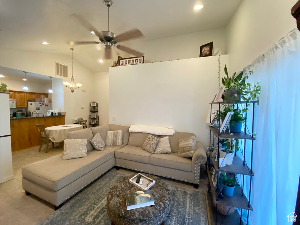 Living area featuring ceiling fan, a chandelier, vaulted ceiling, and recessed lighting