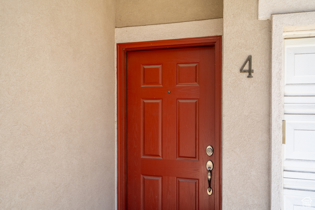 Property entrance featuring stucco siding