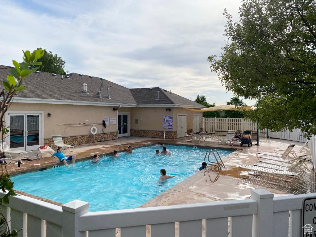 Community pool with a patio