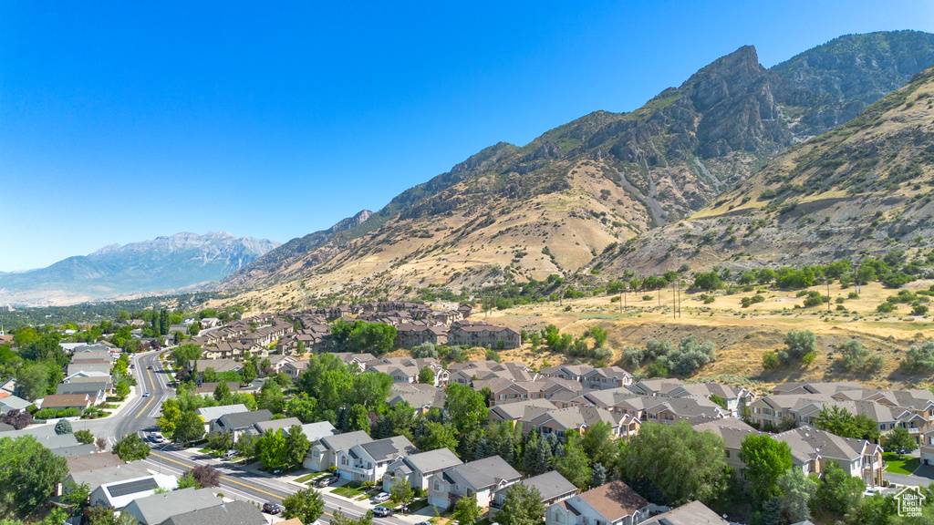 Aerial view of property\'s location with nearby suburban area and a mountainous background