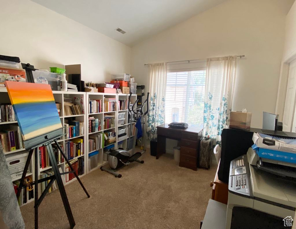 Carpeted home office featuring lofted ceiling