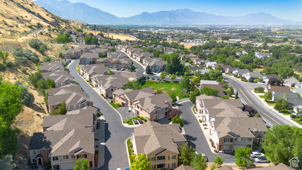 Aerial view of property\'s location with nearby suburban area and a mountainous background