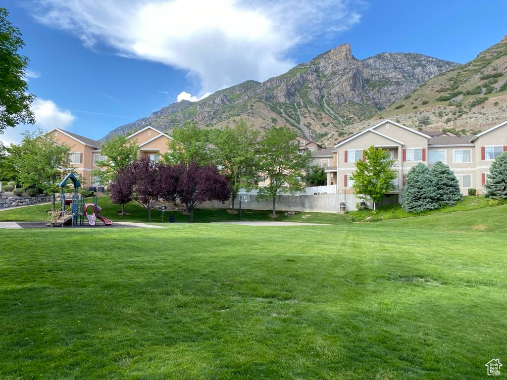 View of grassy yard with a mountain view
