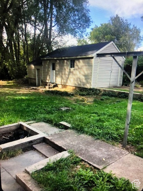View of outdoor structure featuring a vegetable garden