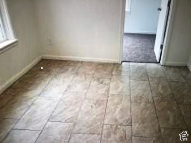 Unfurnished dining area featuring baseboards