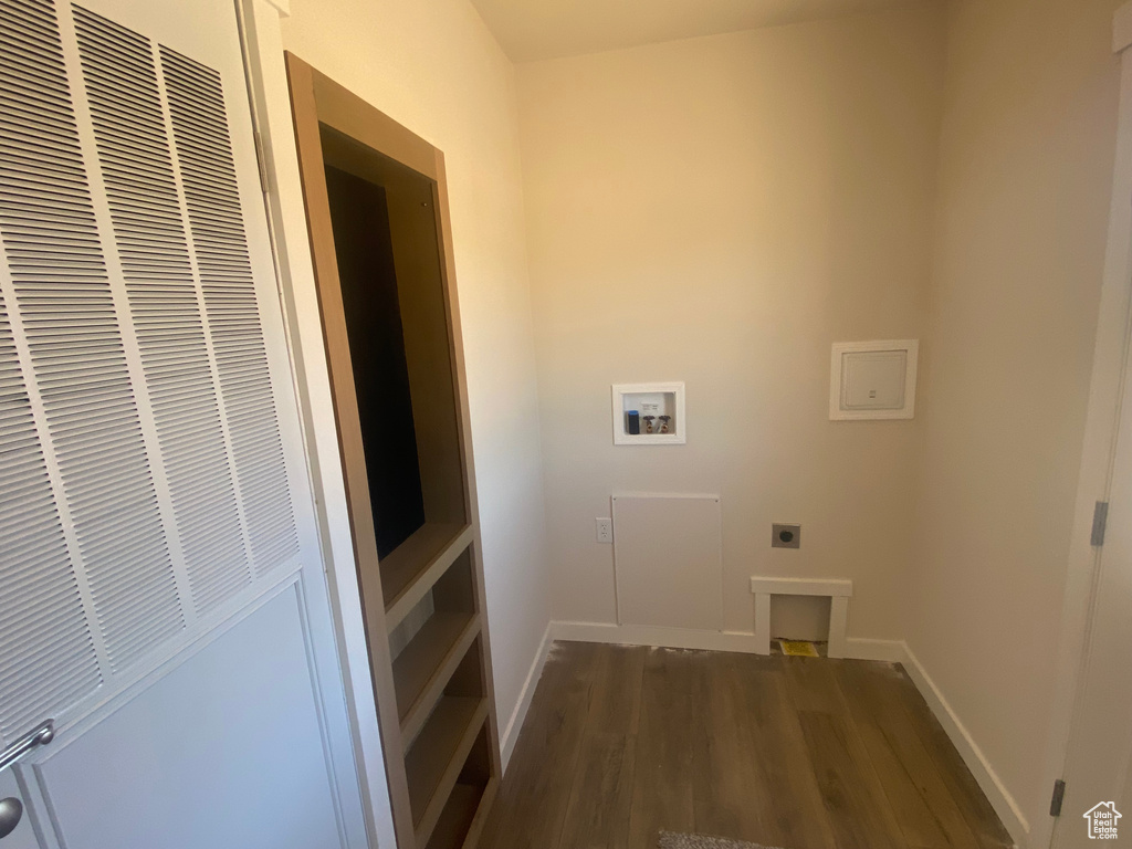 Laundry area featuring hookup for a washing machine, a heating unit, electric dryer hookup, wood finished floors, and baseboards