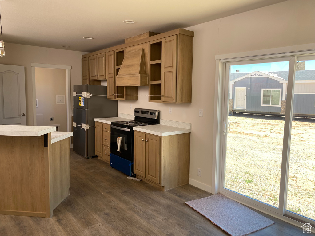 Kitchen with stainless steel electric range oven, freestanding refrigerator, light countertops, dark wood-style floors, and recessed lighting