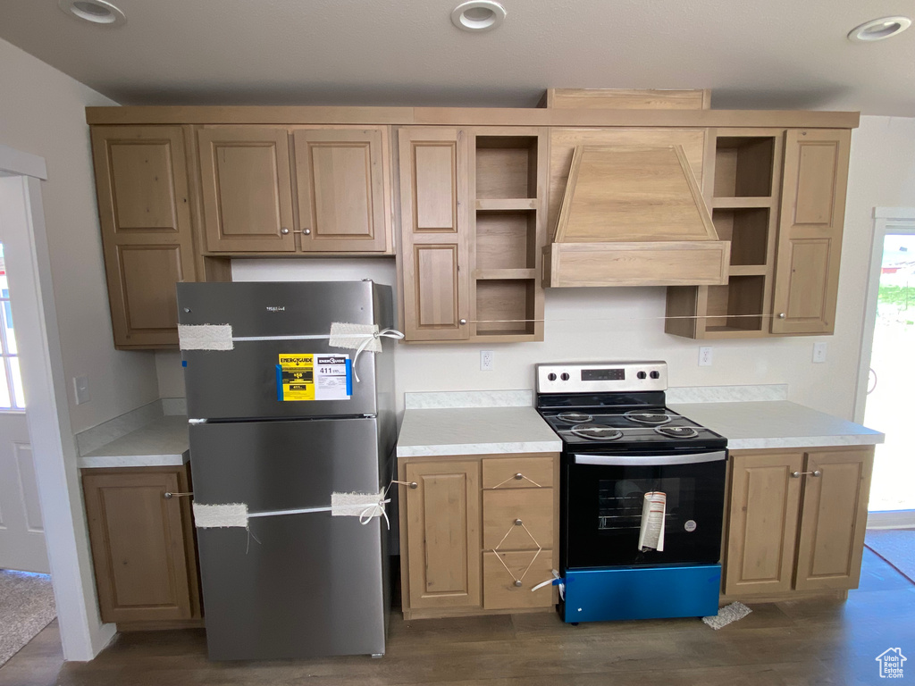 Kitchen featuring electric range, freestanding refrigerator, custom range hood, open shelves, and light countertops
