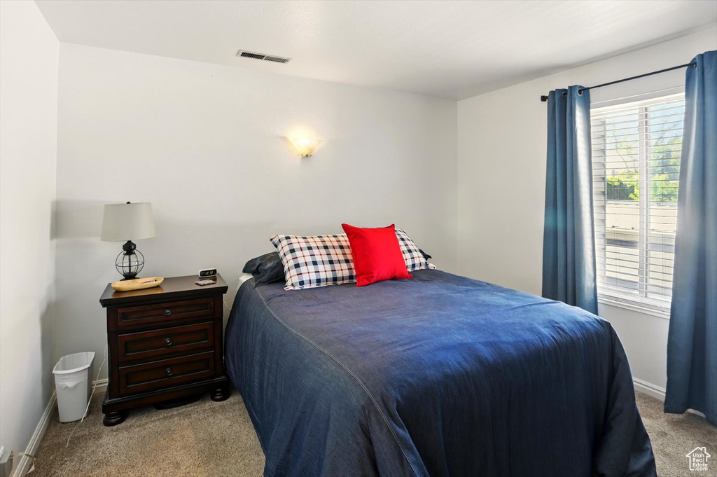 Carpeted bedroom featuring baseboards