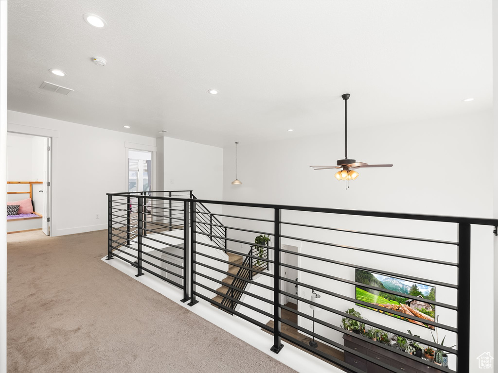 Hall featuring an upstairs landing, carpet, recessed lighting, and baseboards