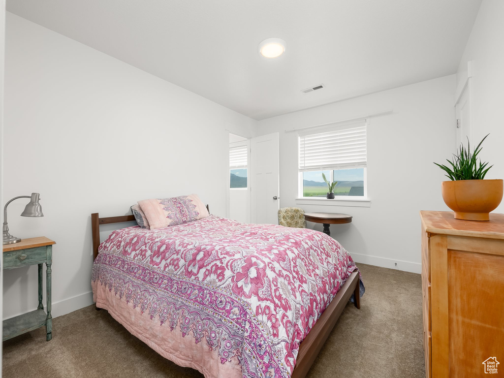 Bedroom with carpet flooring and baseboards