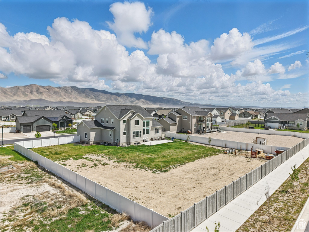 Back of property featuring a residential view, a fenced backyard, and a mountain view