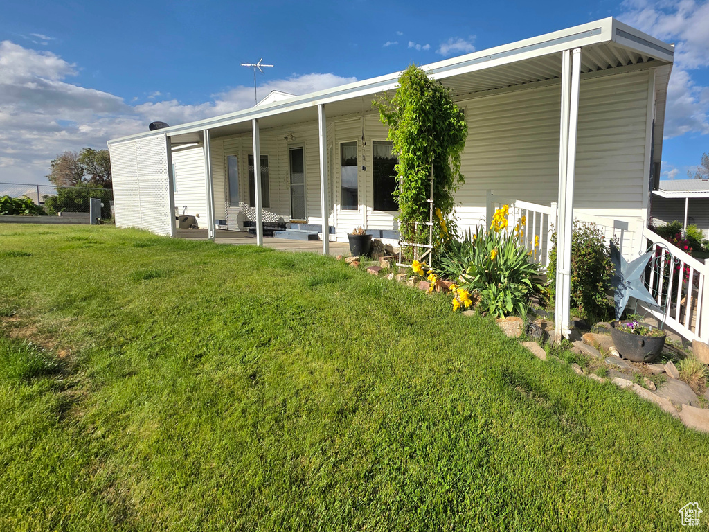 Rear view of property with a yard