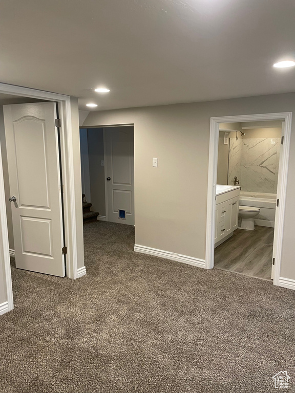 Unfurnished bedroom with carpet flooring, baseboards, recessed lighting, and ensuite bathroom