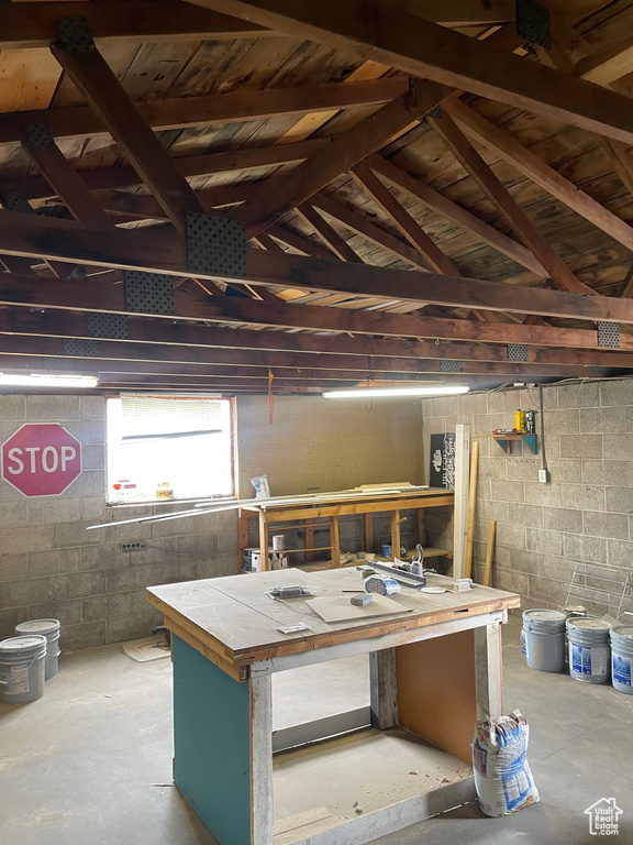Basement with a workshop area and concrete block wall