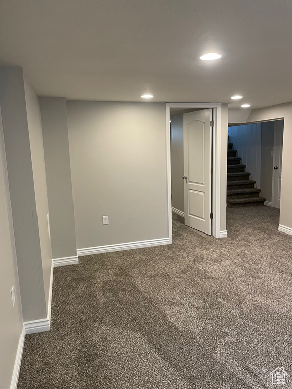 Finished below grade area featuring baseboards, carpet floors, recessed lighting, and stairs
